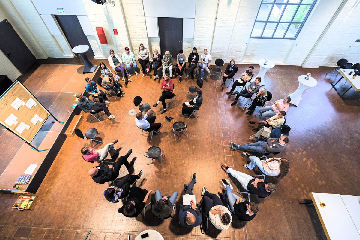 Fish Bowl: Menschen sprechen miteinander